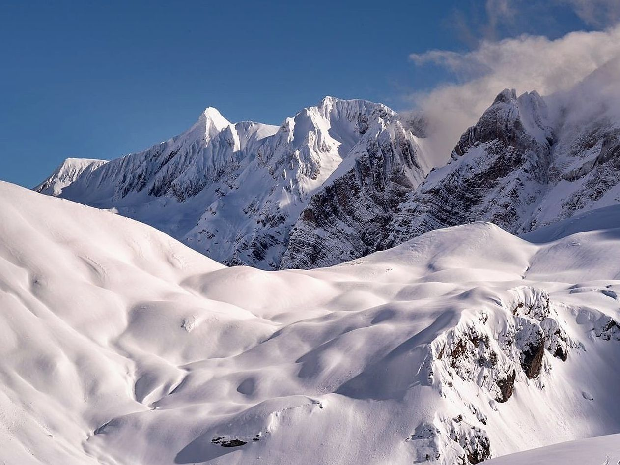 Mountain fishing grounds above the treeline, covered in fresh snow